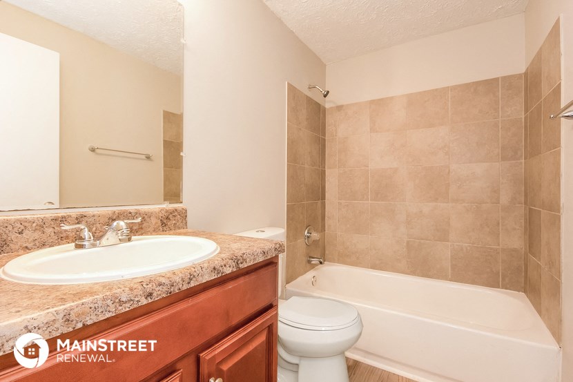 a bathroom with a sink toilet and a bath tub