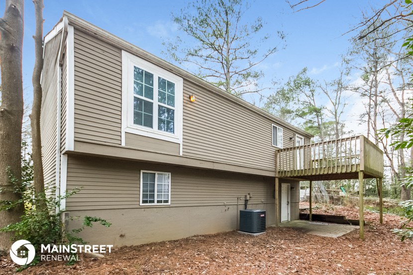 the exterior of a home with a deck and a balcony