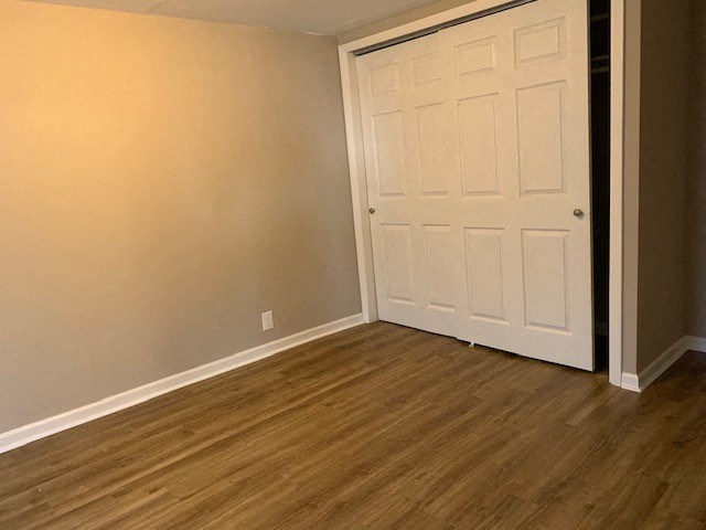 a white door in a room with a wooden floor