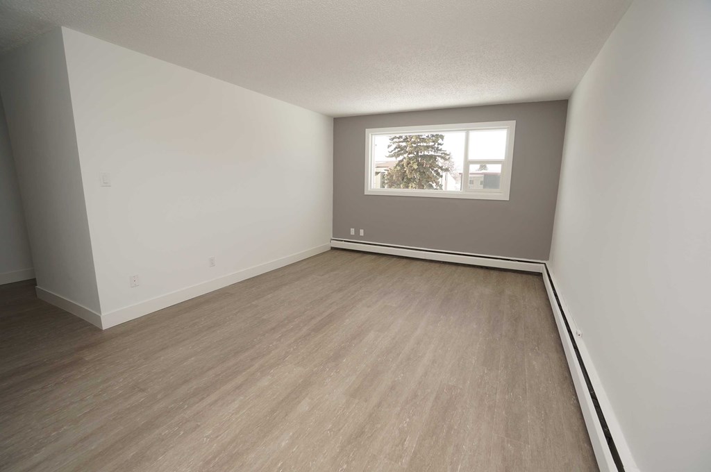 an empty room with white walls and a window