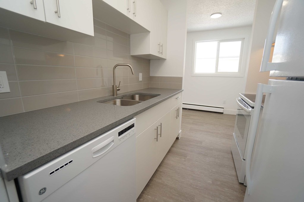 a kitchen with white cabinets and a sink