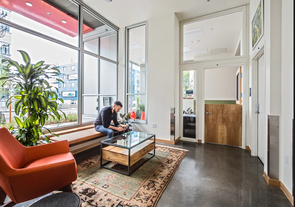 a man sitting in a living room with a coffee table