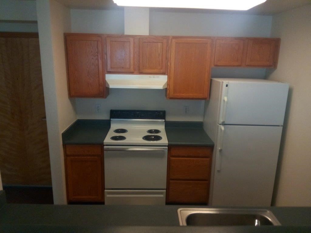 a kitchen with a stove and a refrigerator