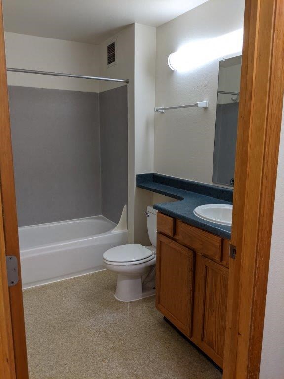 a bathroom with a toilet and a sink and a shower