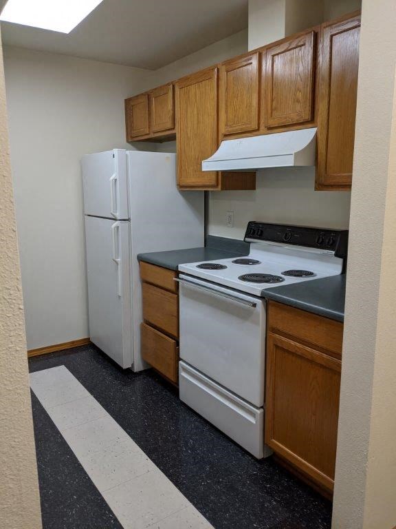 a kitchen with a stove and a refrigerator
