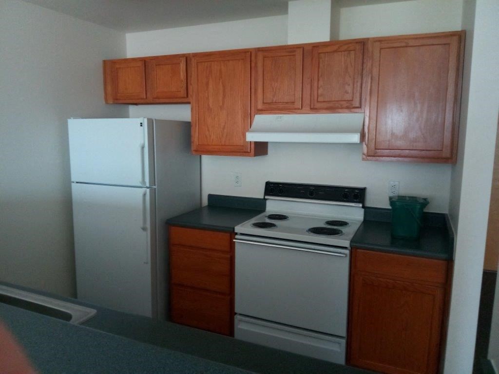 a kitchen with a stove and a refrigerator
