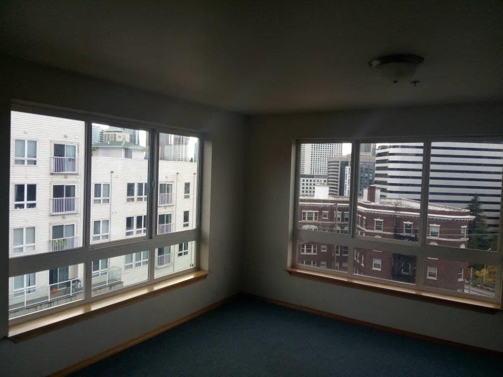 a room with windows and a view of a city