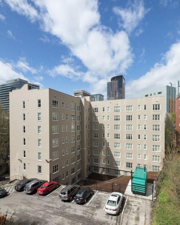 a parking lot with cars in front of a building