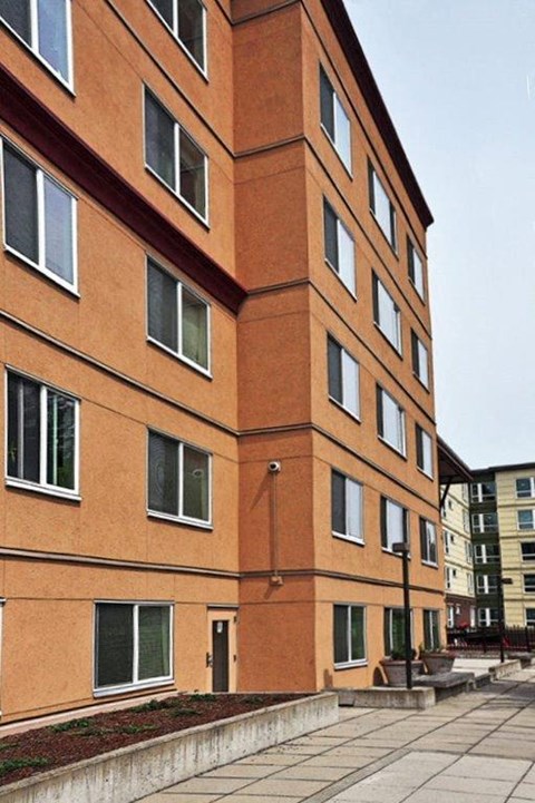 a tall brick building with windows on the side of it