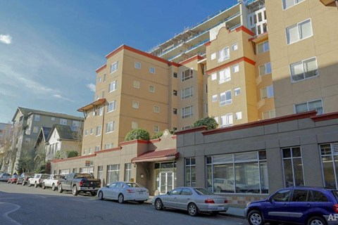 a city street with cars parked in front of buildings