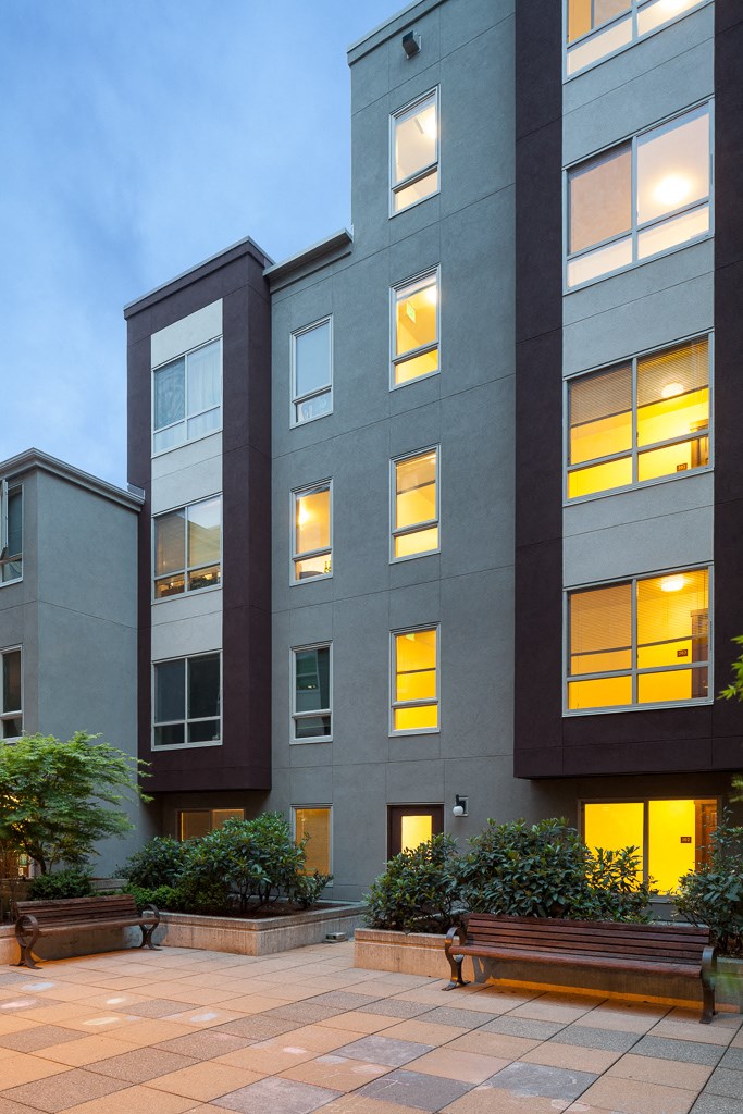 a group of buildings with their windows lit up at night