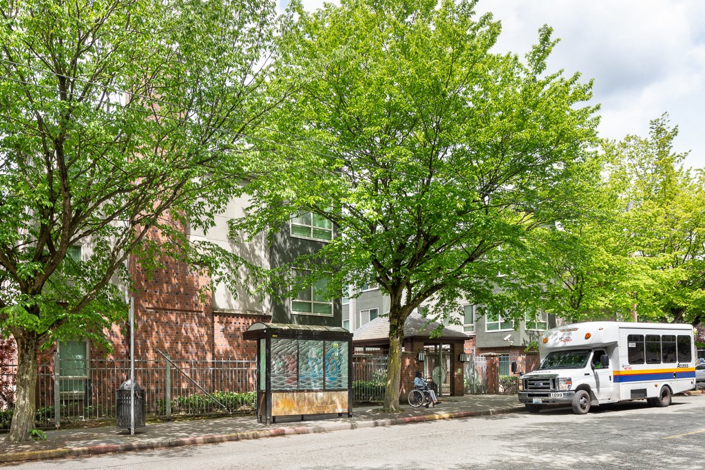 a bus is parked at a bus stop on a city street