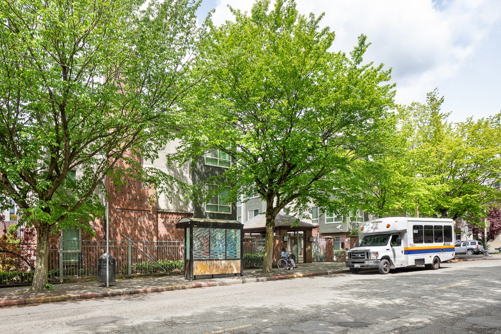 a bus is parked on a street in front of a building