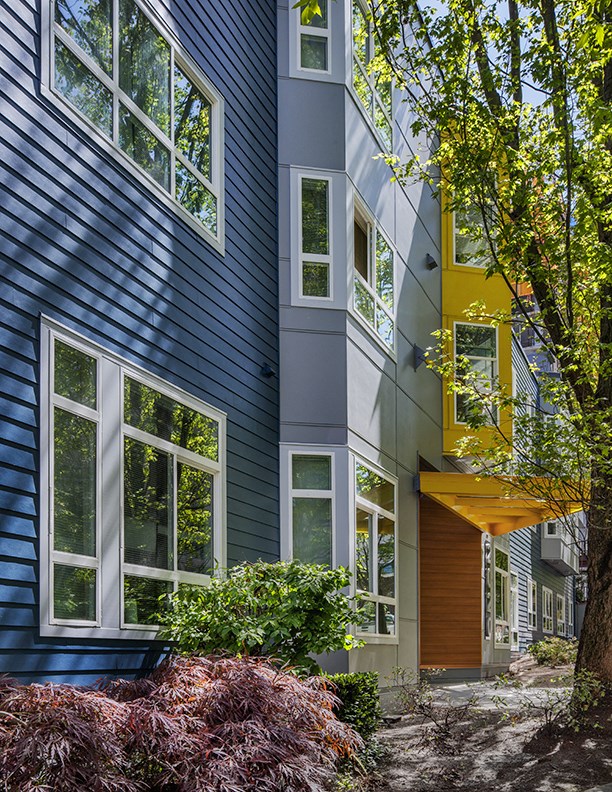 a house with blue and yellow siding and windows
