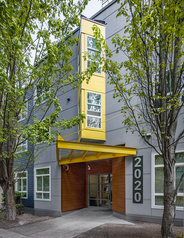 the facade of a building with a yellow tower on top of it