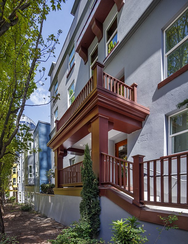 a house with a balcony on a city street