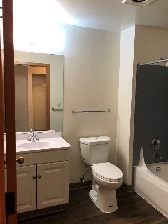 a white bathroom with a toilet and a sink