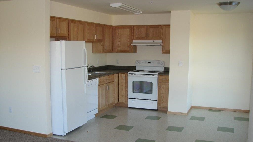 a kitchen with a stove and a refrigerator