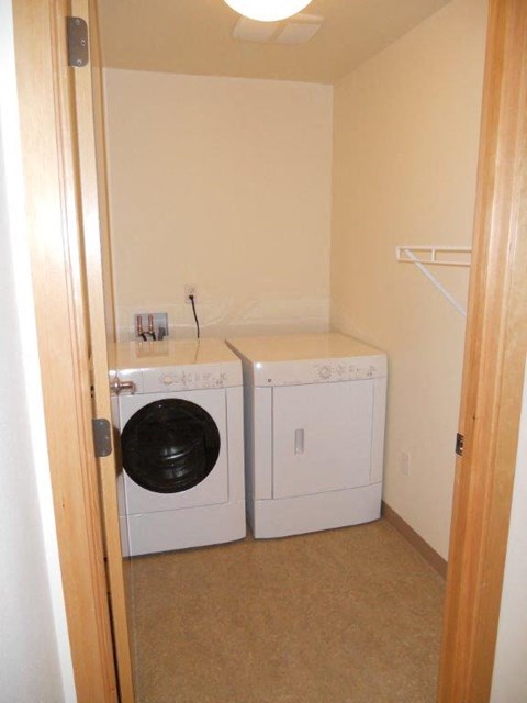 A small laundry room with a washer and dryer.