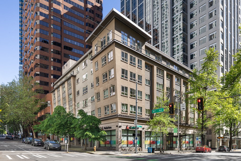 A street view of a city with a building in the middle.