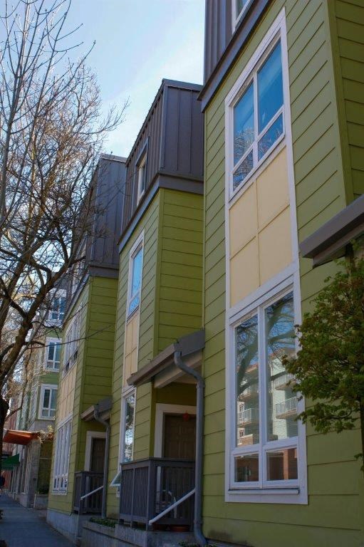 a yellow and green house with a window