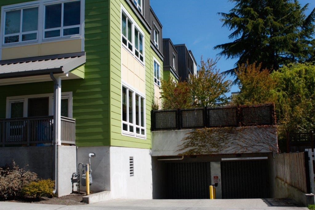a green and white building with a garage