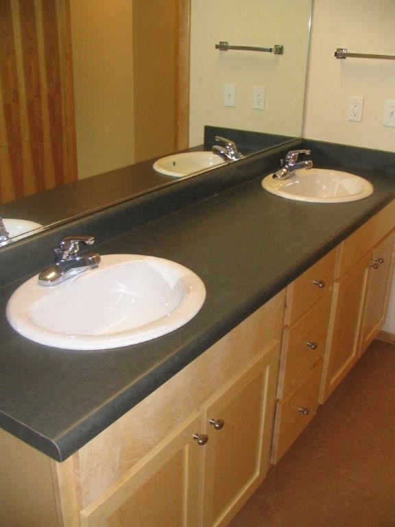 a bathroom with two sinks and a mirror