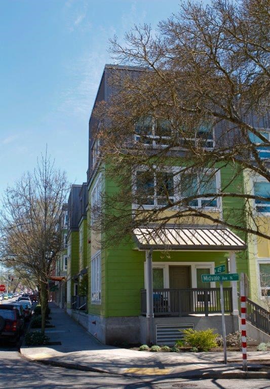 a green building on the corner of a street
