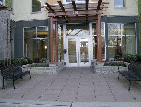 the front entrance of a building with two benches