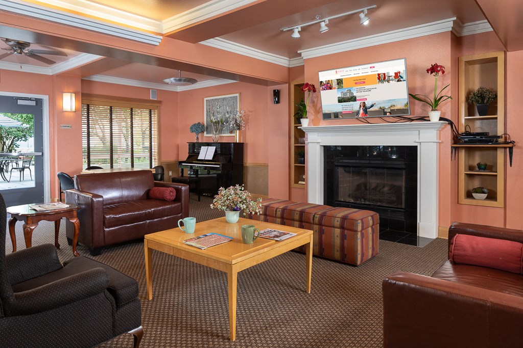 a living room with brown leather furniture and a fireplace
