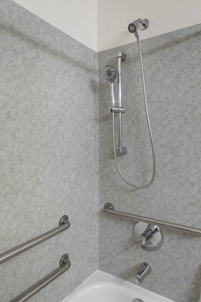 a bathroom with a shower and a white sink