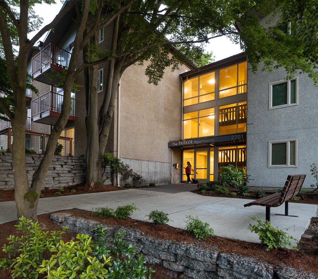 the exterior of a building with a courtyard and a bench