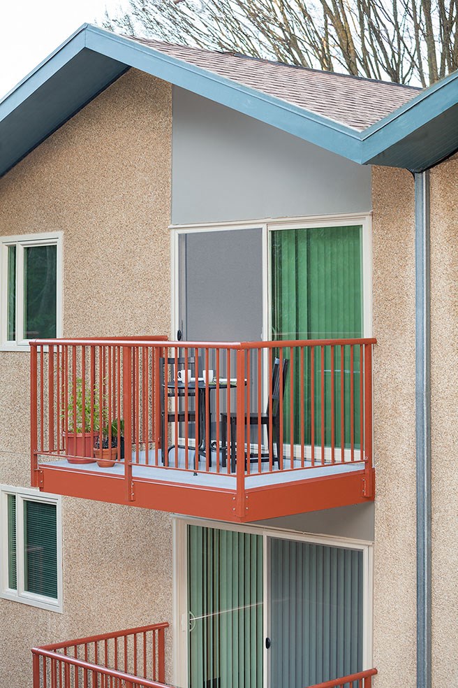 a balcony of a house with a red railing