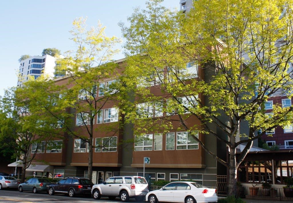 a large building with cars parked in front of it
