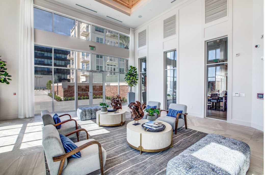 a living room with furniture and large windows