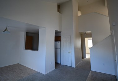 Image of space with carpet near kitchen and stairs