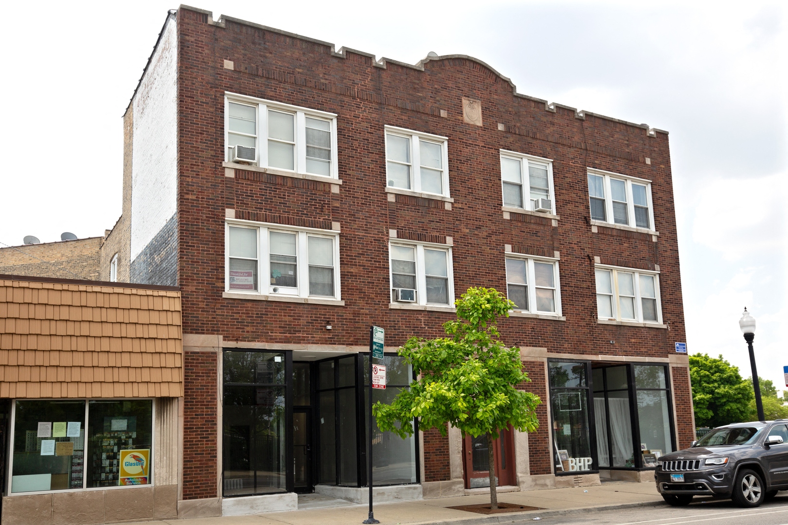 a brick building with a car parked in front of it