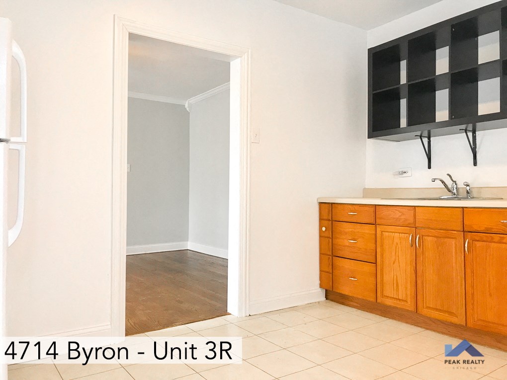 a room with a sink and a mirror and a door to a bathroom