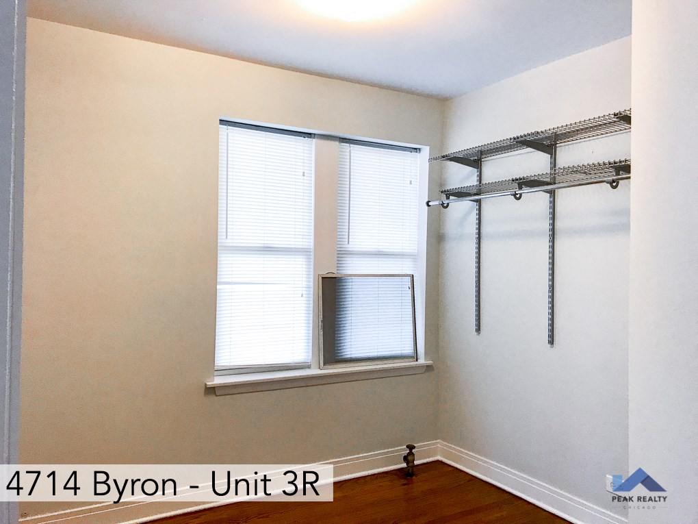 a room with two windows and a wall with a window and a closet with a