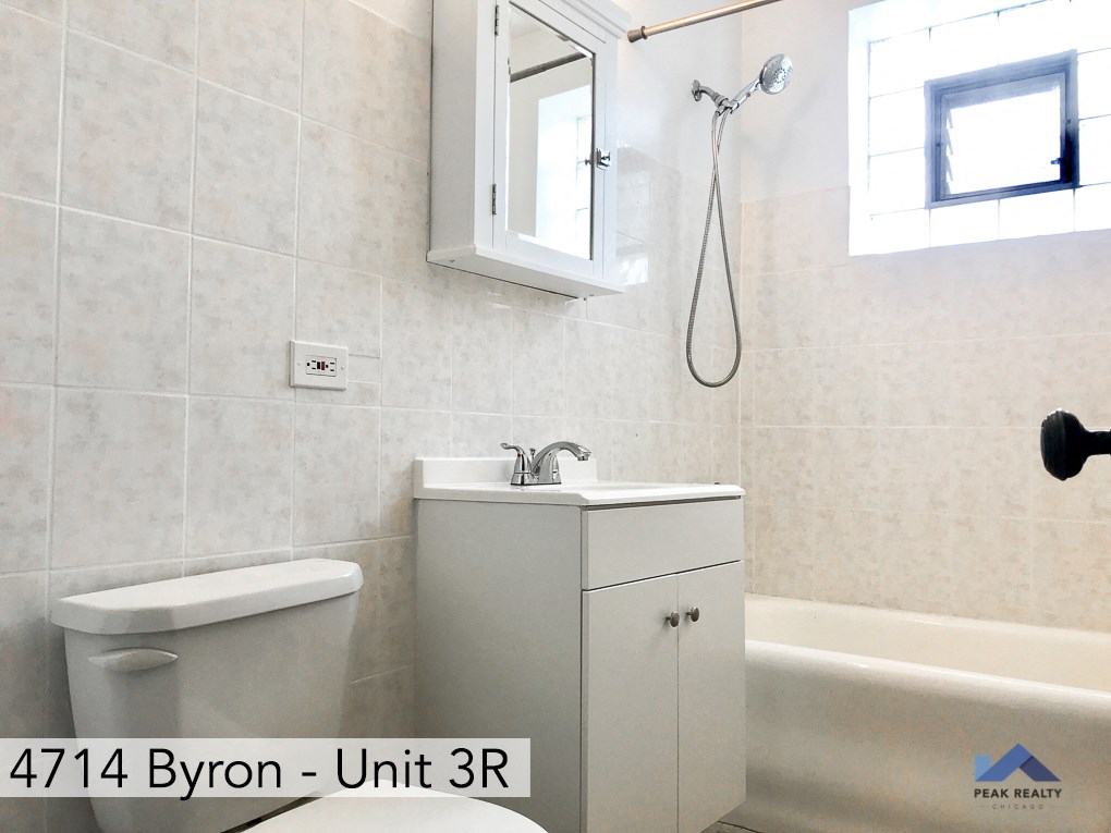 an ensuite bathroom with a sink and a toilet and a bath tub