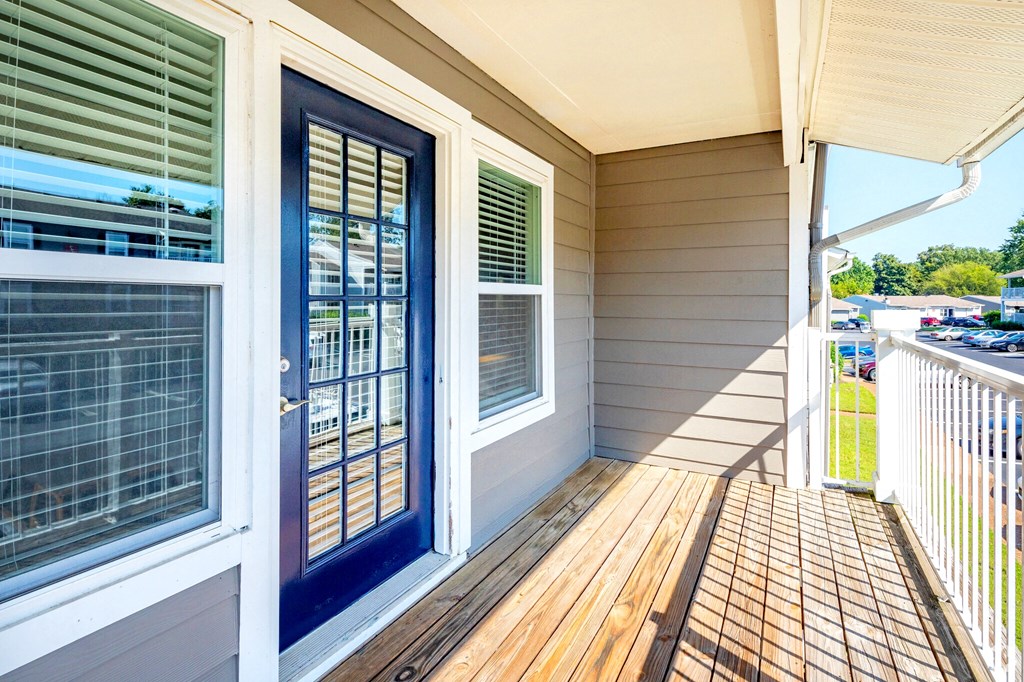 the front porch of a house with a blue door