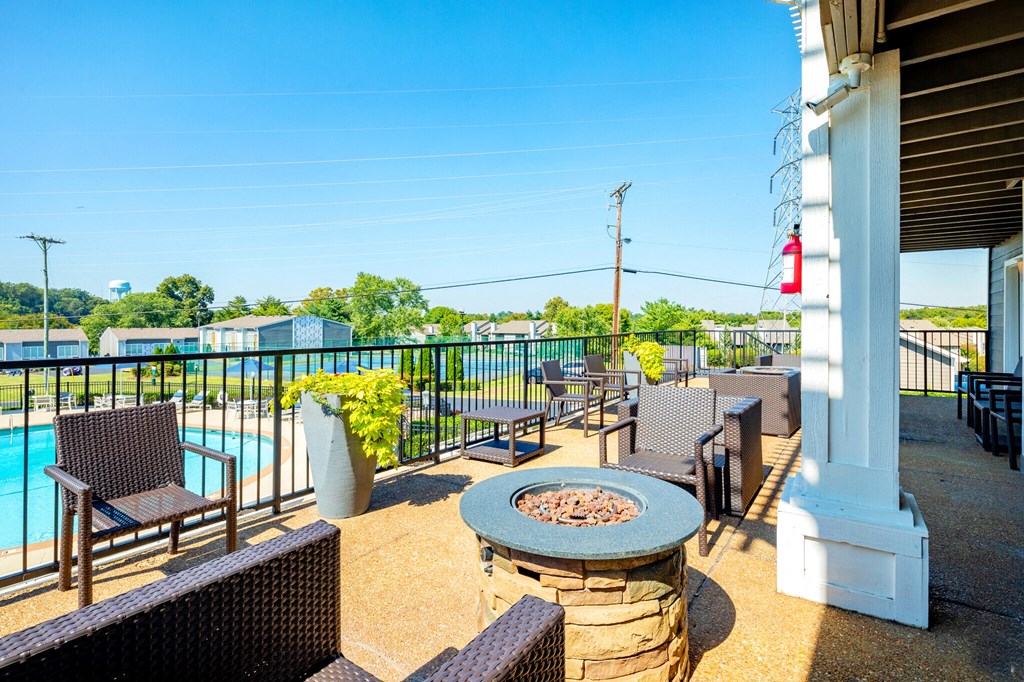 a patio with tables and chairs and a swimming pool