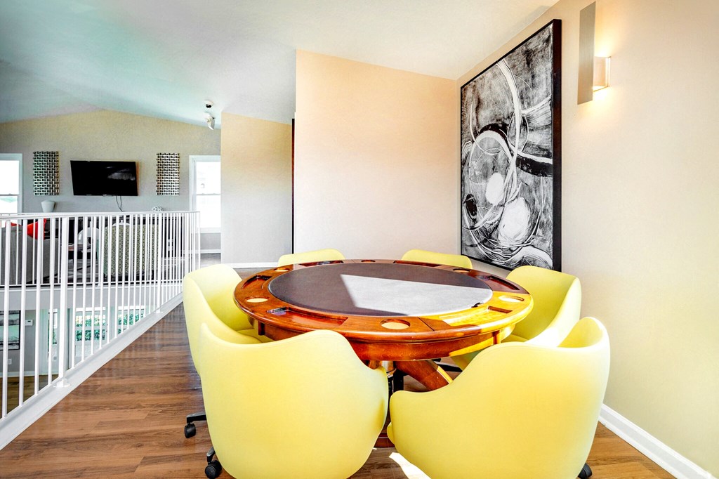 a dining room with yellow chairs and a wooden table