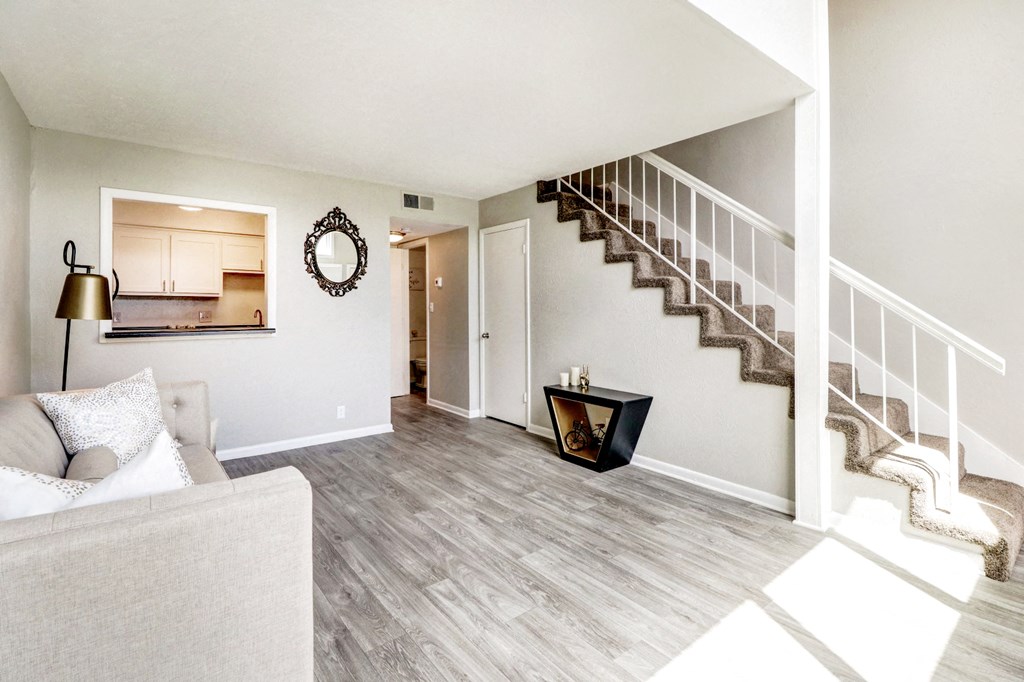 the living room of a home with stairs and a couch
