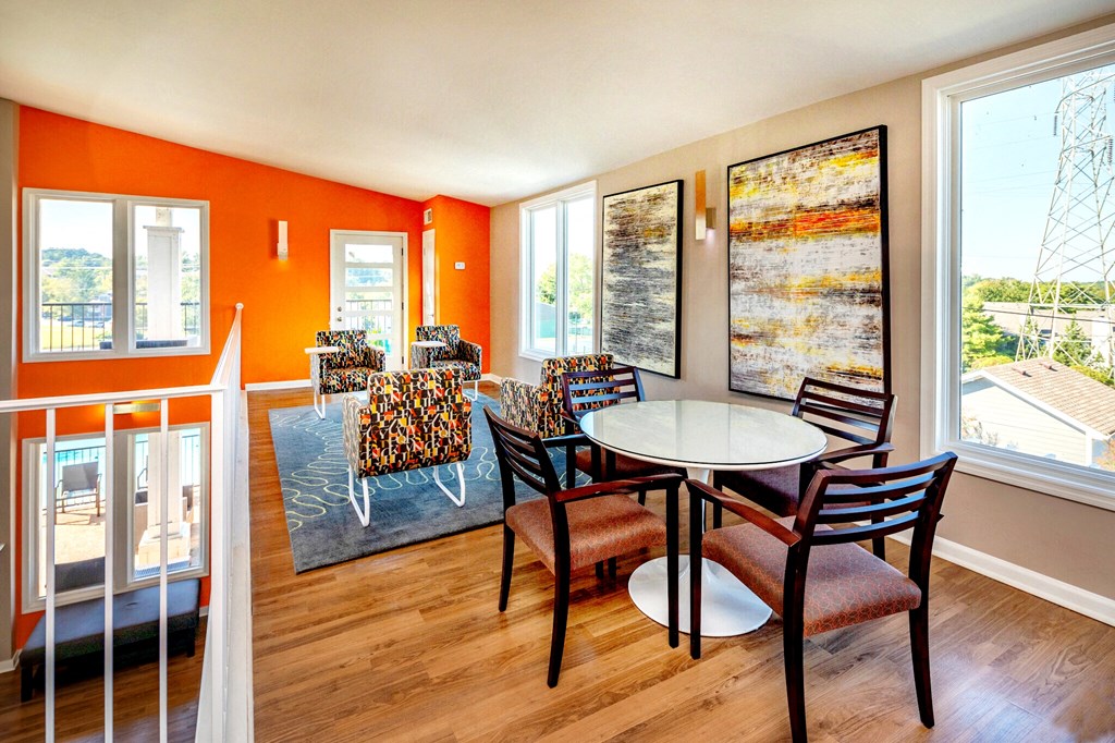 a dining room with a table and chairs