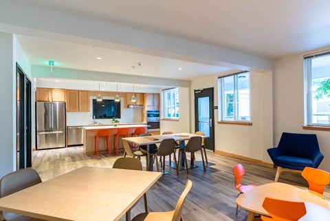 A modern dining room with a long table and chairs.
