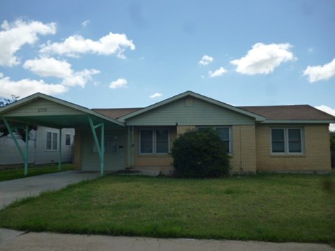 the front of a house with a covered porch