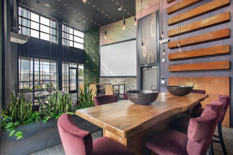 a dining room with a wooden table and chairs