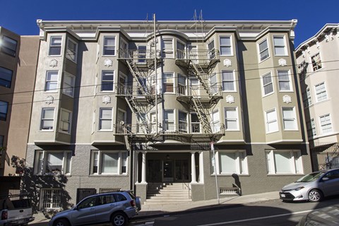 A large apartment building with a fire escape on the side.