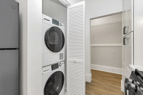 A white dryer is on the left of a white washer.